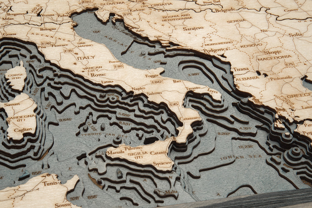 Western Europe 3D layered wood map in laser-cut Baltic birch, shown framed against a light wall