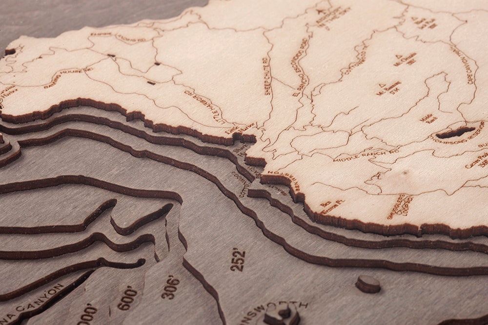 Catalina Island, California 3D layered wood map in laser-cut Baltic birch, shown framed against a light wall
