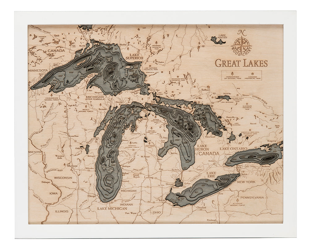 Great Lakes 3D layered wood map in laser-cut Baltic birch, shown framed against a light wall