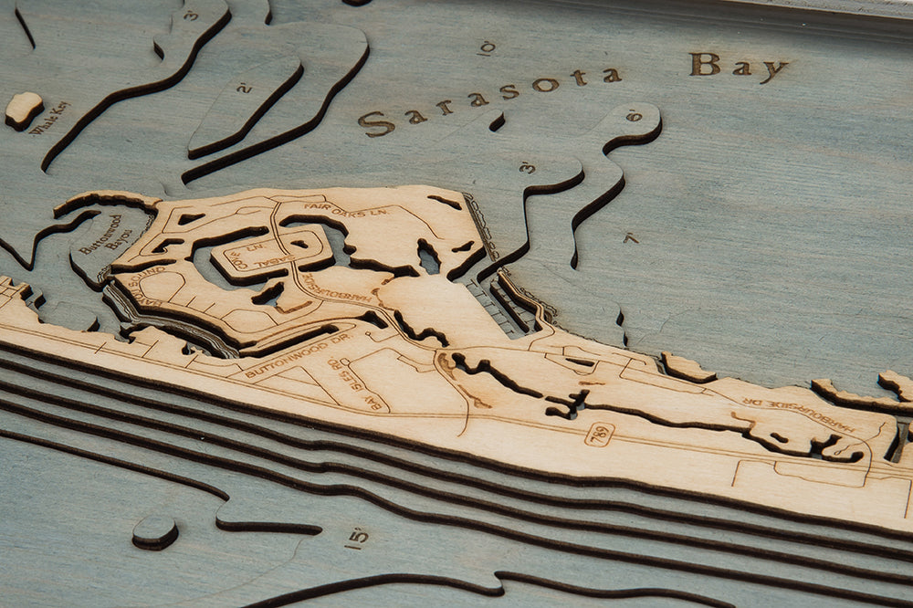 Longboat Key, Florida 3D layered wood map in laser-cut Baltic birch, shown framed against a light wall