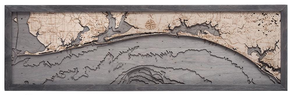 Western Panhandle, Florida 3D layered wood map in laser-cut Baltic birch, shown framed against a light wall