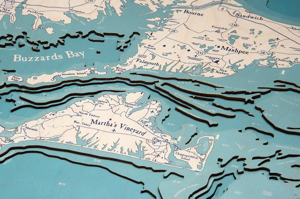 Cape Cod, Massachusetts 3D layered wood map in laser-cut Baltic birch, shown framed against a light wall