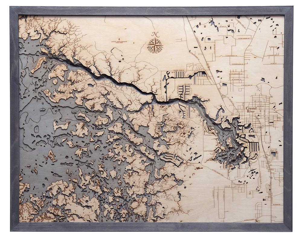 Crystal River, Florida 3D layered wood map in laser-cut Baltic birch, shown framed against a light wall