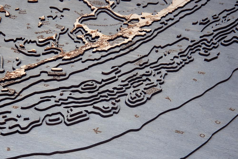 Upper Florida Keys 3D layered wood map in laser-cut Baltic birch, shown framed against a light wall
