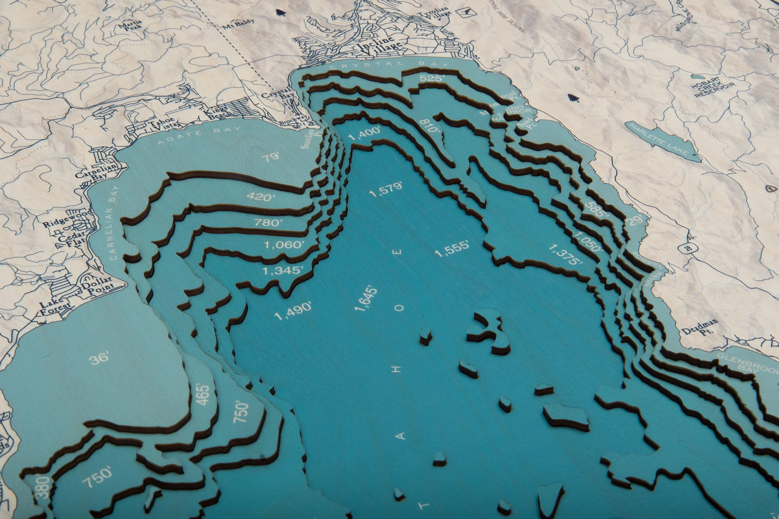 Lake Tahoe, California 3D layered wood map in laser-cut Baltic birch, shown framed against a light wall