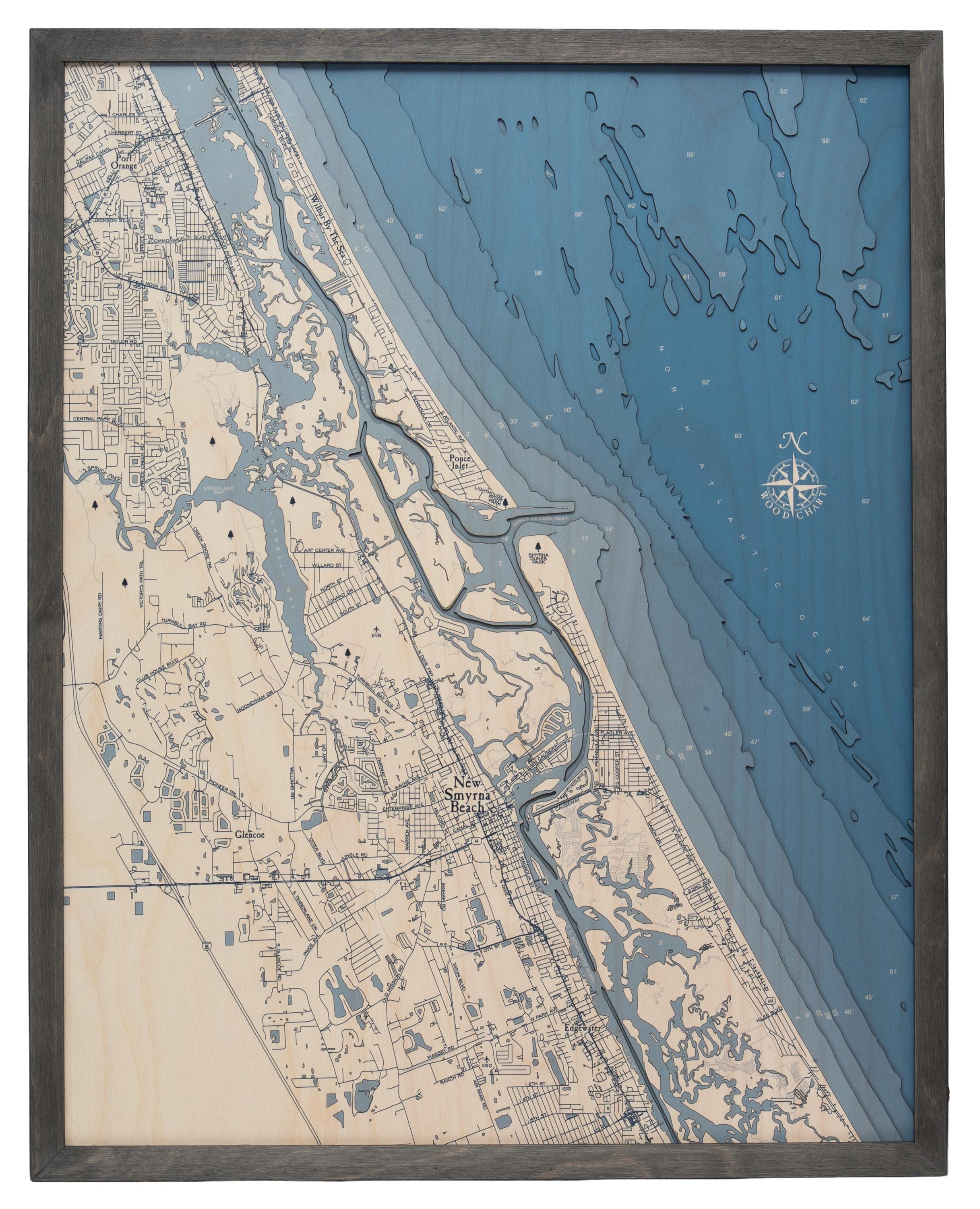 New Smyrna Beach, Florida 3D layered wood map in laser-cut Baltic birch, shown framed against a light wall