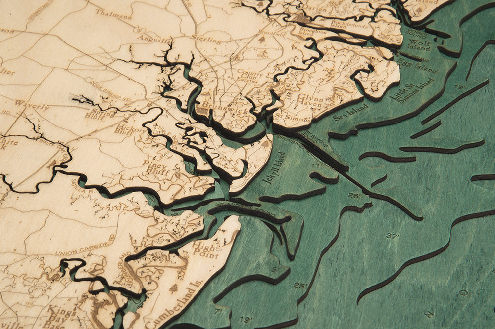 Georgia Coast 3D layered wood map in laser-cut Baltic birch, shown framed against a light wall
