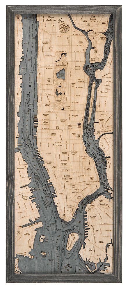 Manhattan, New York 3D layered wood map in laser-cut Baltic birch, shown framed against a light wall