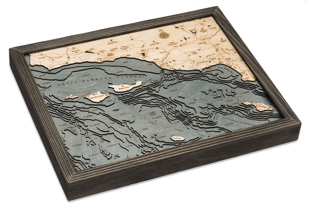 Santa Barbara, California 3D layered wood map in laser-cut Baltic birch, shown framed against a light wall