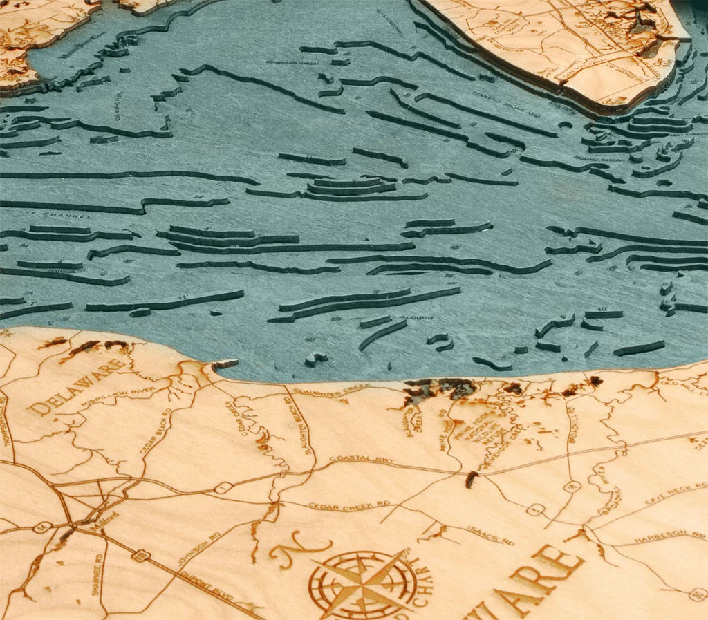 Delaware Bay 3D layered wood map in laser-cut Baltic birch, shown framed against a light wall