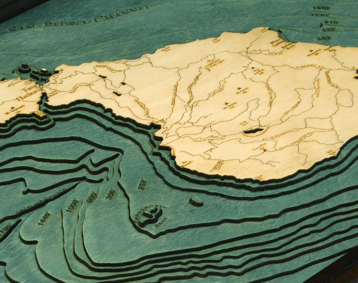 Catalina Island, California 3D layered wood map in laser-cut Baltic birch, shown framed against a light wall