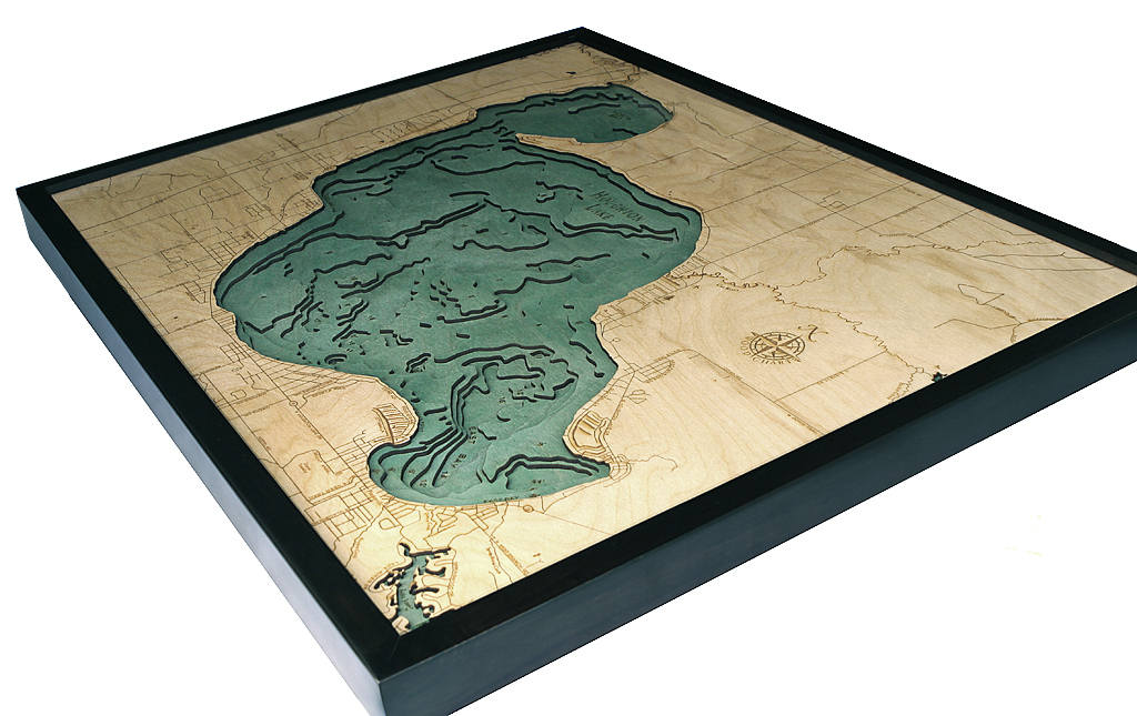 Houghton Lake, Michigan 3D layered wood map in laser-cut Baltic birch, shown framed against a light wall