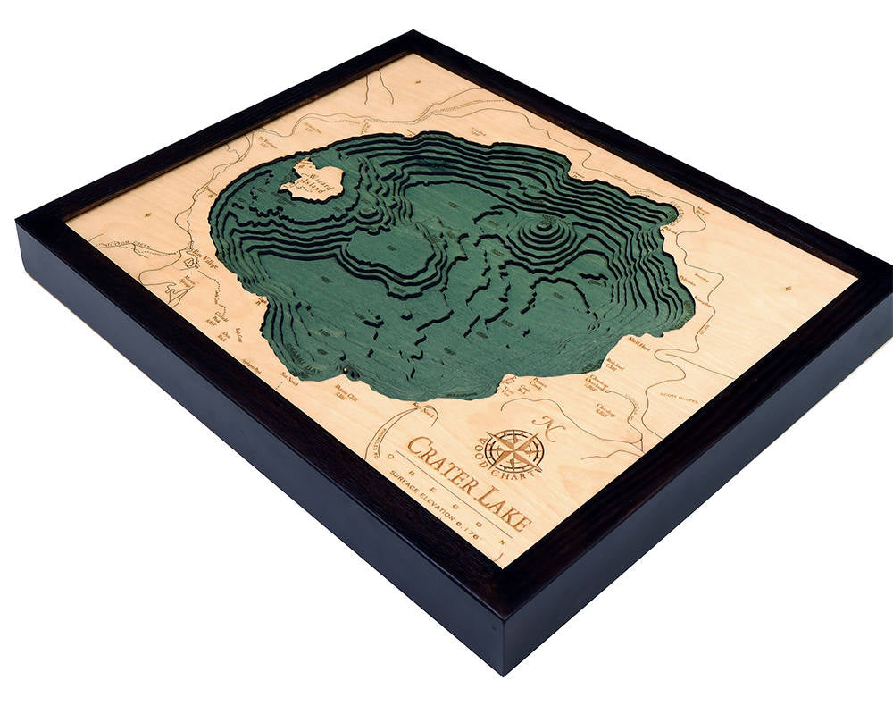 Crater Lake, Oregon 3D layered wood map in laser-cut Baltic birch, shown framed against a light wall