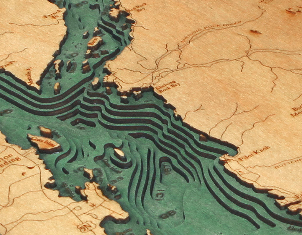 Lake George, New York 3D layered wood map in laser-cut Baltic birch, shown framed against a light wall
