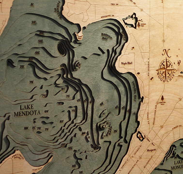 Lake Mendota & Monona, Wisconsin 3D layered wood map in laser-cut Baltic birch, shown framed against a light wall