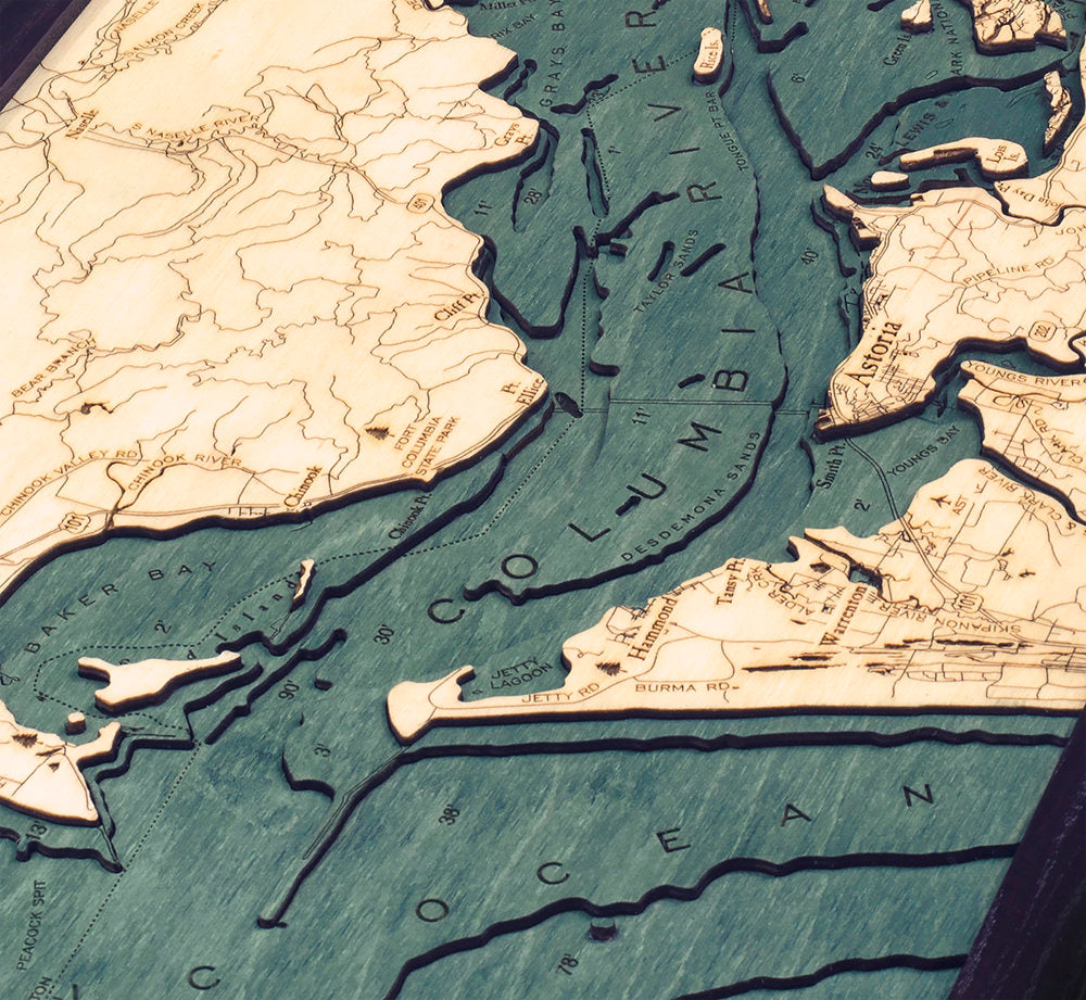 Columbia River Mouth, Oregon 3D layered wood map in laser-cut Baltic birch, shown framed against a light wall