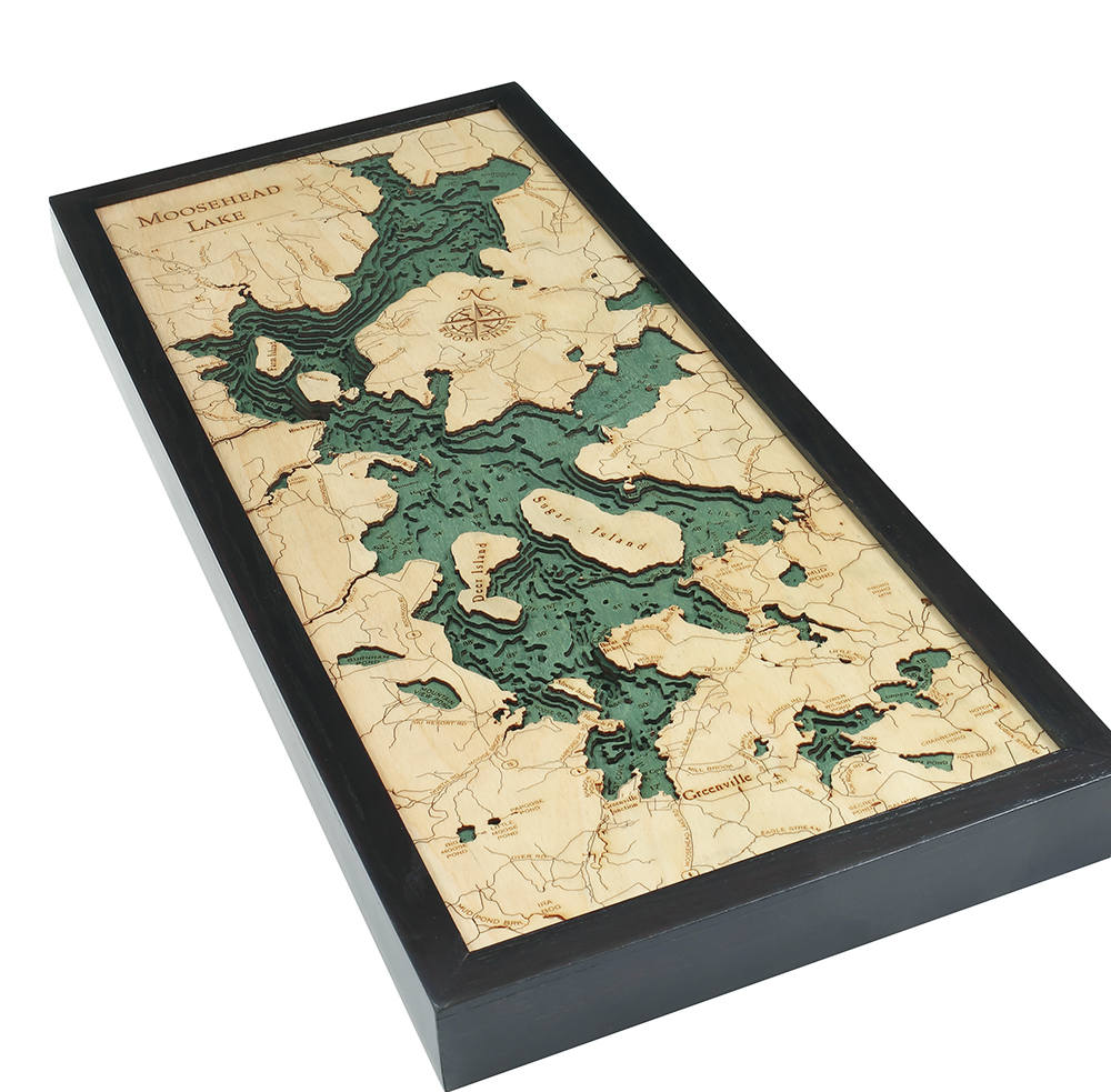 Moosehead Lake, Maine 3D layered wood map in laser-cut Baltic birch, shown framed against a light wall