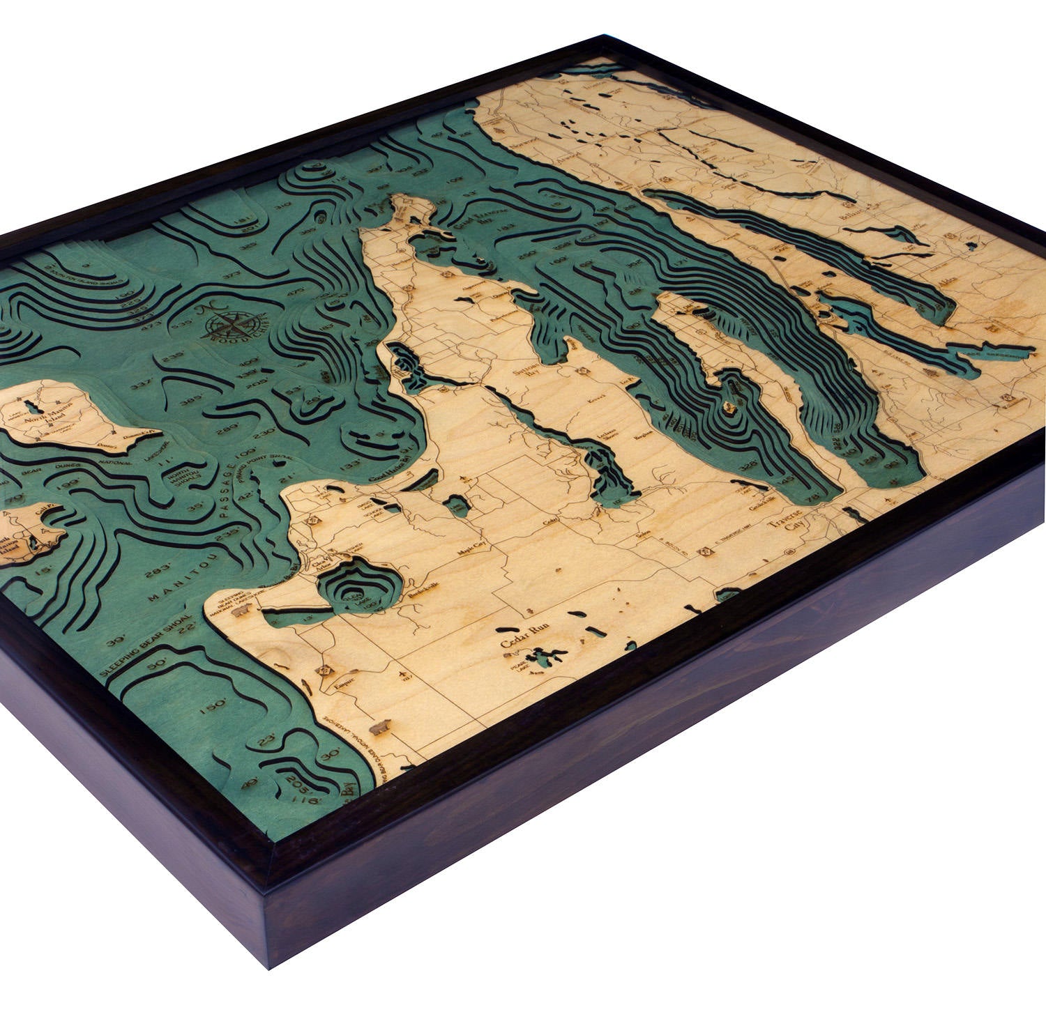 Grand Traverse Bay, Michigan 3D layered wood map in laser-cut Baltic birch, shown framed against a light wall