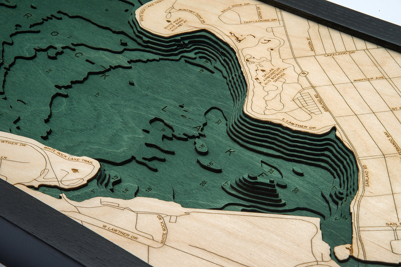 White Rock Lake, Texas 3D layered wood map in laser-cut Baltic birch, shown framed against a light wall