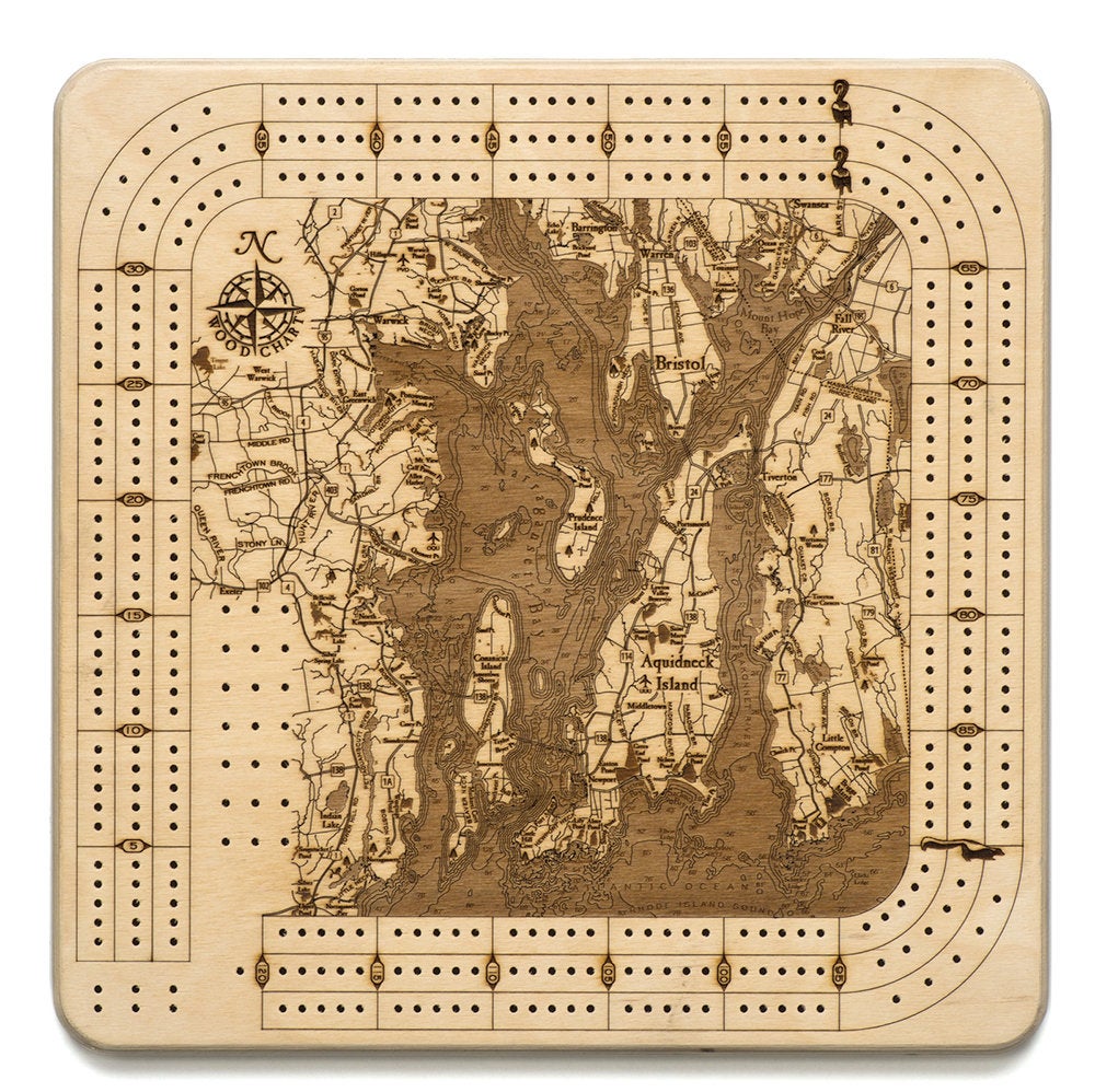 Narragansett, Rhode Island wood cribbage board in laser-cut Baltic birch, shown framed against a light wall