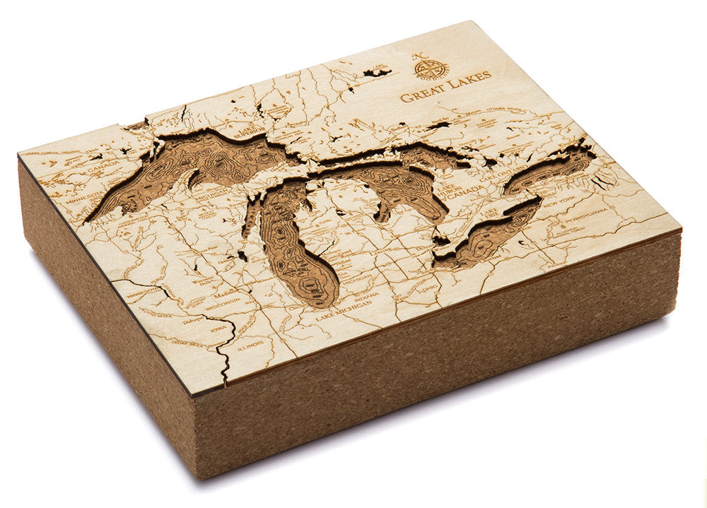 Great Lakes framed cork map in laser-cut Baltic birch, shown framed against a light wall