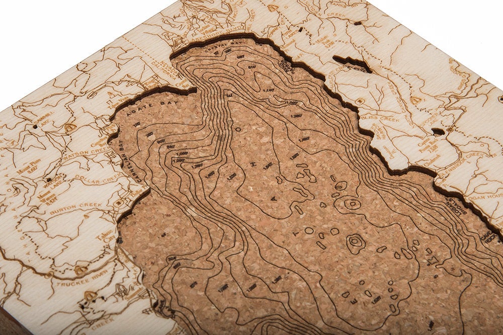 Lake Tahoe, California framed cork map in laser-cut Baltic birch, shown framed against a light wall