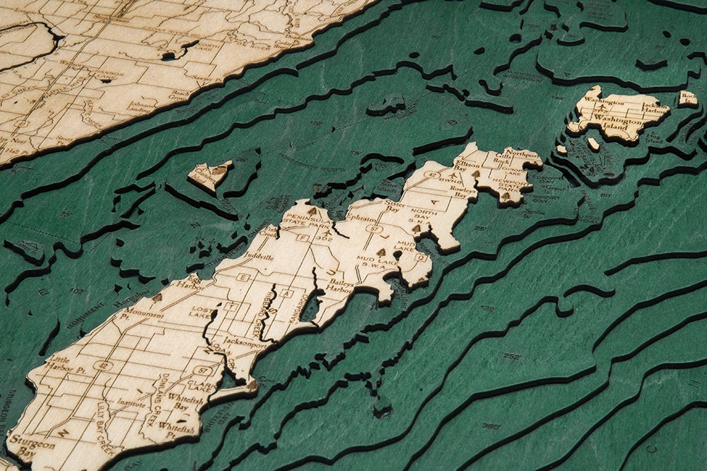 Door County, Wisconsin 3D layered wood map in laser-cut Baltic birch, shown framed against a light wall