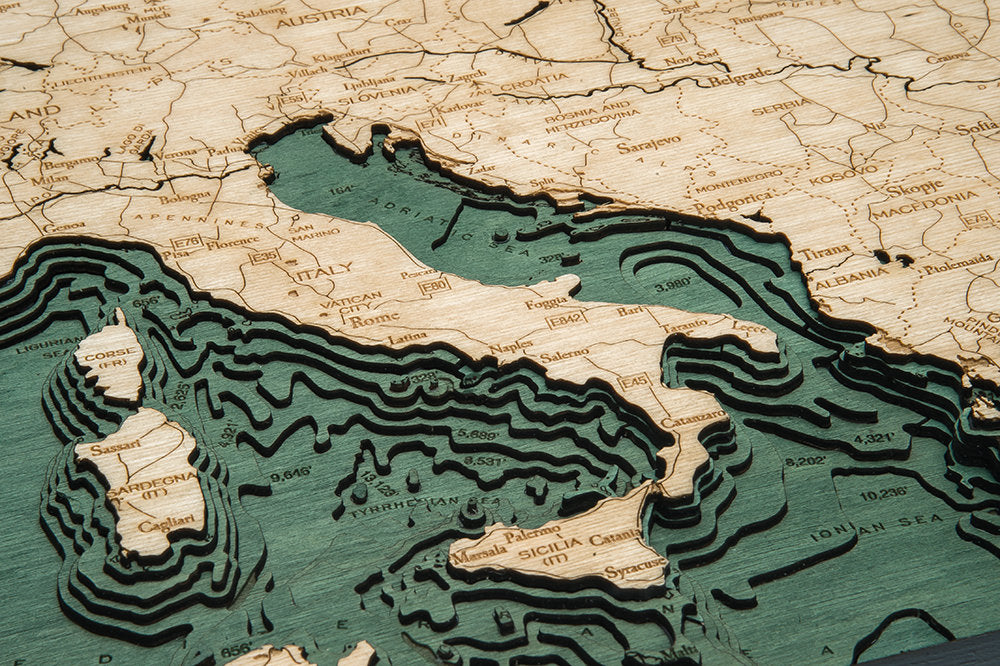 Western Europe 3D layered wood map in laser-cut Baltic birch, shown framed against a light wall