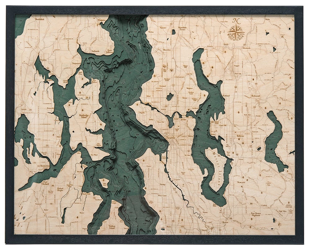 Seattle, Washington 3D layered wood map in laser-cut Baltic birch, shown framed against a light wall