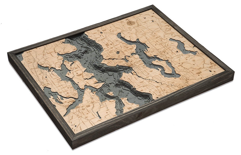 Seattle, Washington 3D layered wood map in laser-cut Baltic birch, shown framed against a light wall