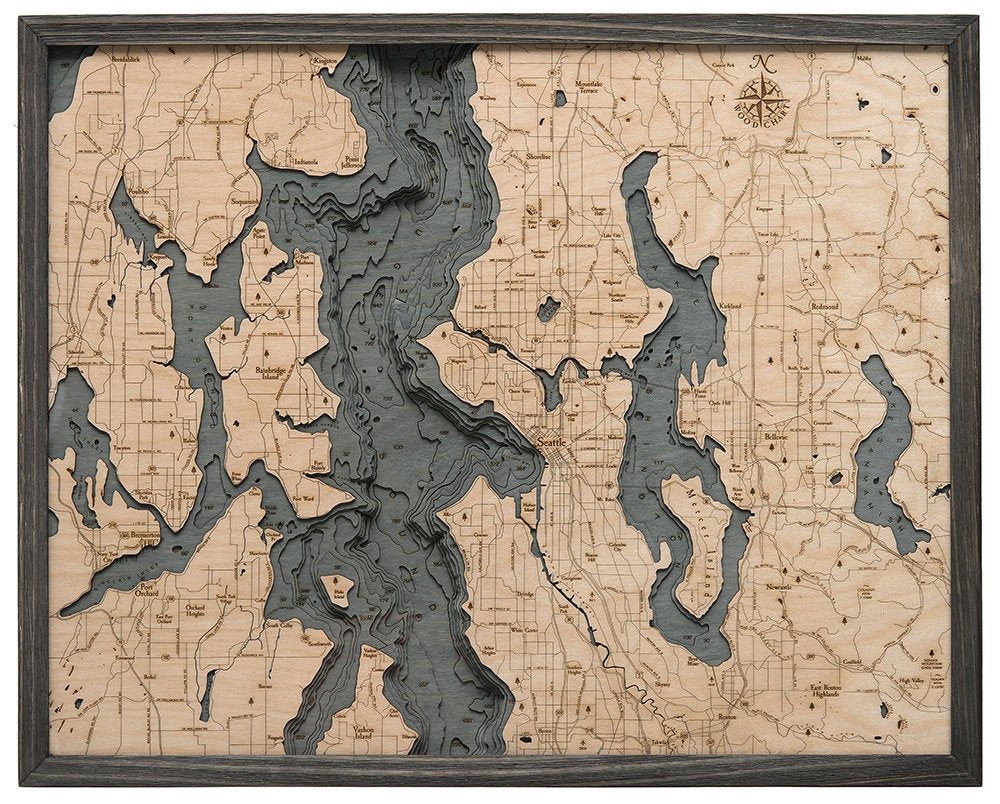 Seattle, Washington 3D layered wood map in laser-cut Baltic birch, shown framed against a light wall