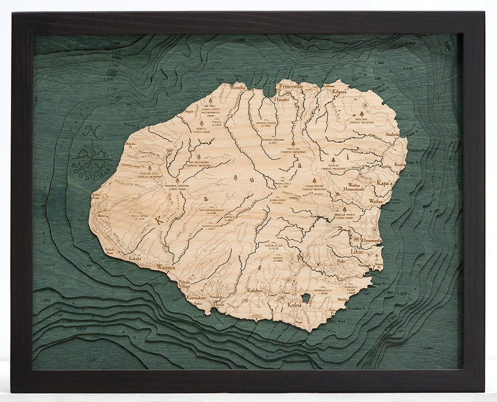 Kauai, Hawaii 3D layered wood map in laser-cut Baltic birch, shown framed against a light wall