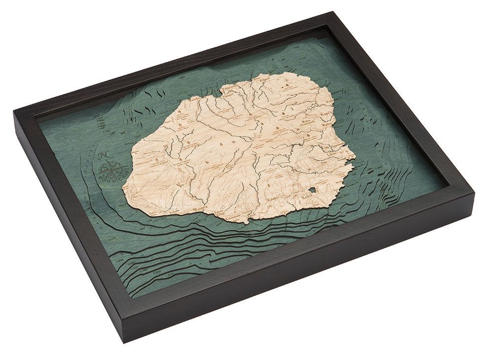 Kauai, Hawaii 3D layered wood map in laser-cut Baltic birch, shown framed against a light wall