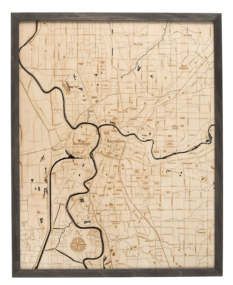Sacramento, California 3D layered wood map in laser-cut Baltic birch, shown framed against a light wall
