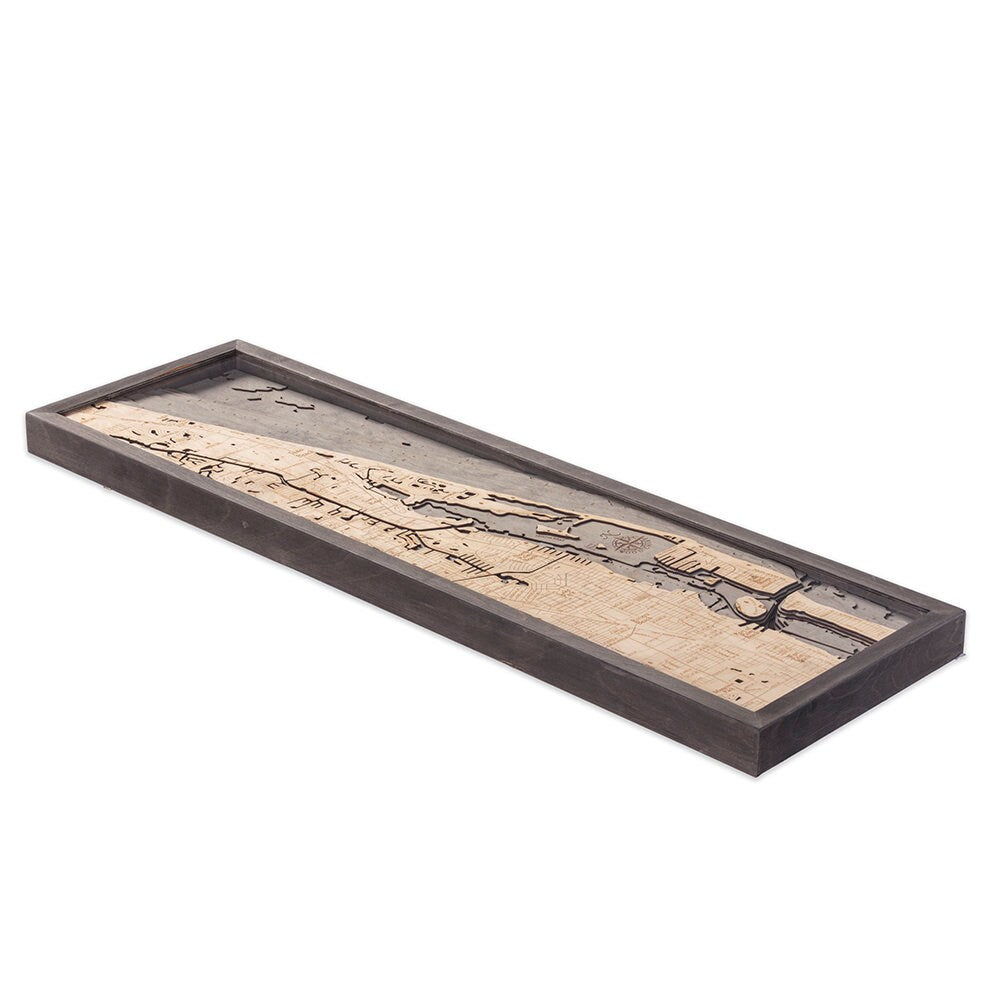 Juno Beach, Florida 3D layered wood map in laser-cut Baltic birch, shown framed against a light wall