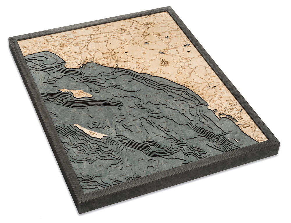 LA to San Diego, California 3D layered wood map in laser-cut Baltic birch, shown framed against a light wall