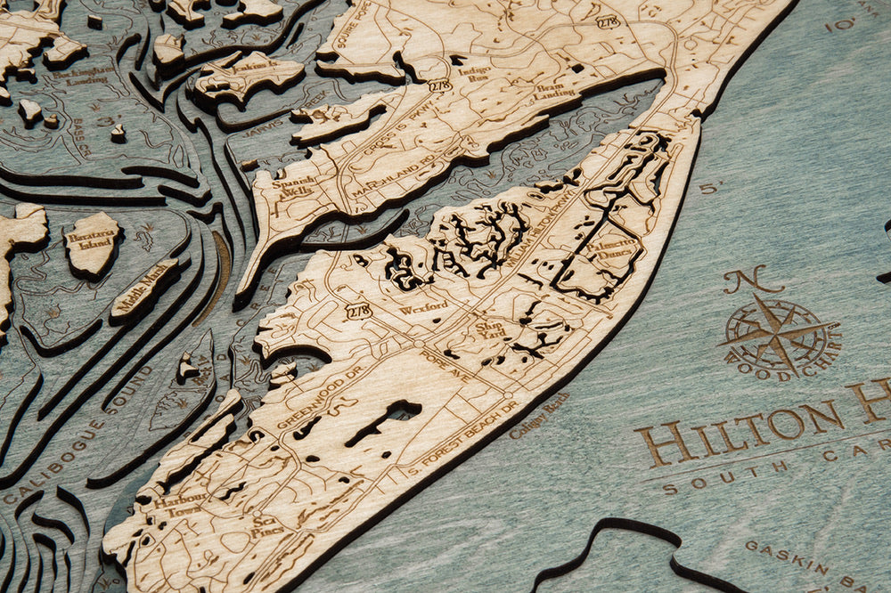 Hilton Head, South Carolina 3D layered wood map in laser-cut Baltic birch, shown framed against a light wall