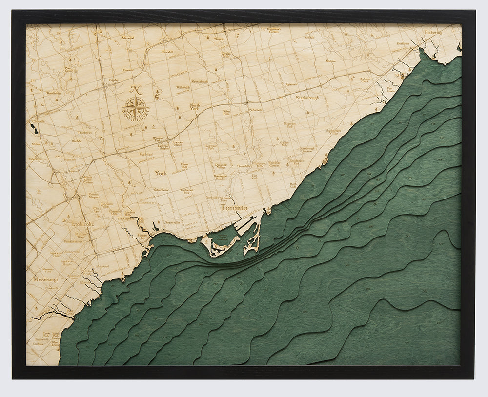 Toronto, Ontario 3D layered wood map in laser-cut Baltic birch, shown framed against a light wall