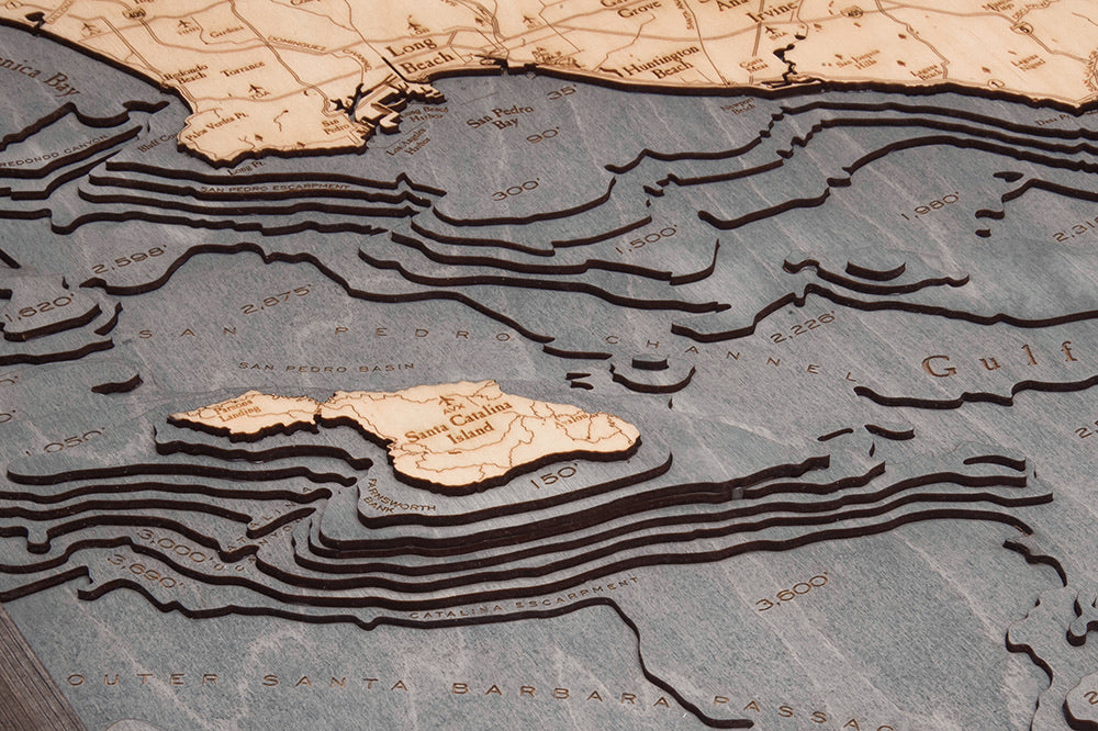 LA to San Diego, California 3D layered wood map in laser-cut Baltic birch, shown framed against a light wall