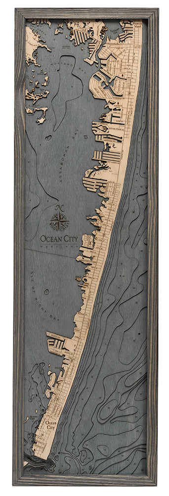 Ocean City, Maryland 3D layered wood map in laser-cut Baltic birch, shown framed against a light wall
