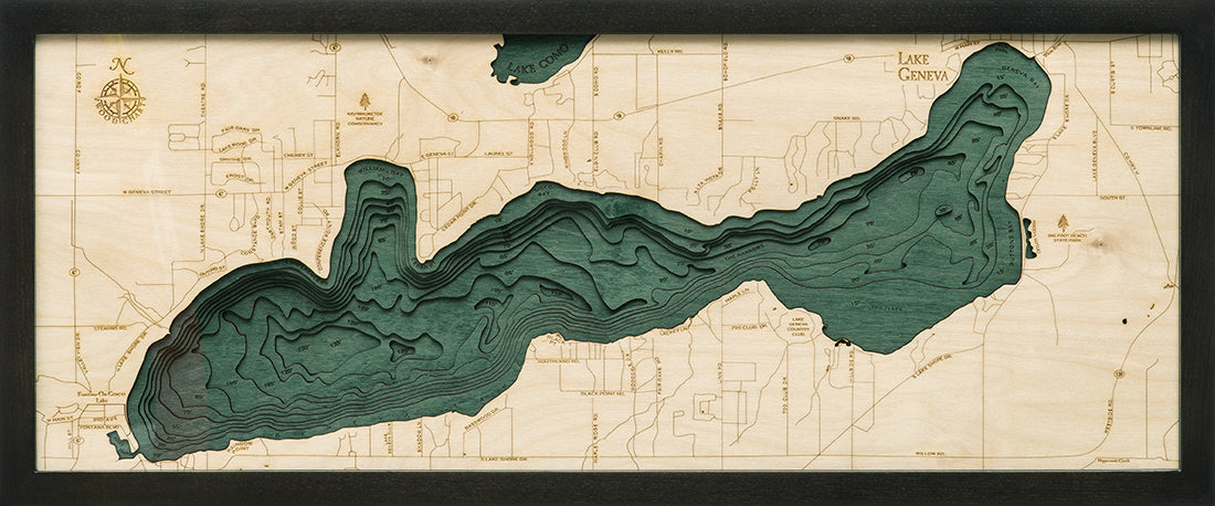 Lake Geneva, Wisconsin 3D layered wood map in laser-cut Baltic birch, shown framed against a light wall