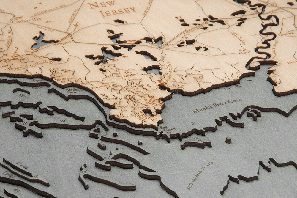 Delaware Bay 3D layered wood map in laser-cut Baltic birch, shown framed against a light wall