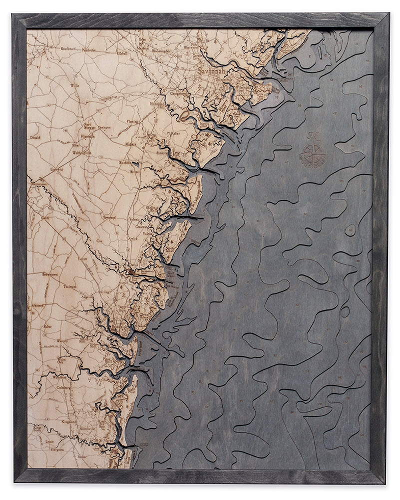 Georgia Coast 3D layered wood map in laser-cut Baltic birch, shown framed against a light wall