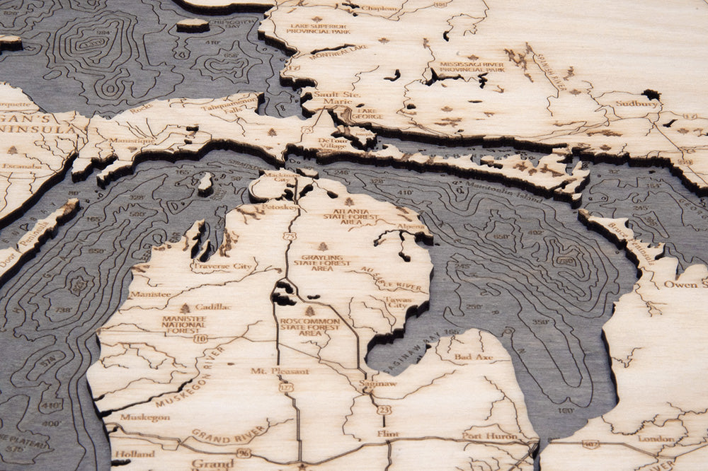 Great Lakes wood serving tray in laser-cut Baltic birch, shown framed against a light wall