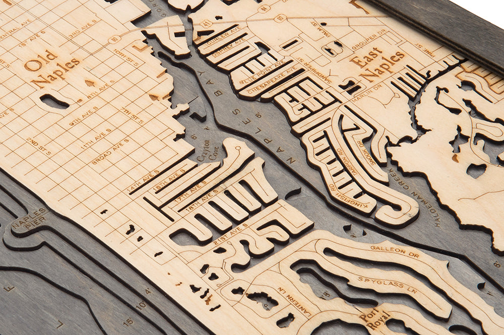 Naples, Florida 3D layered wood map in laser-cut Baltic birch, shown framed against a light wall