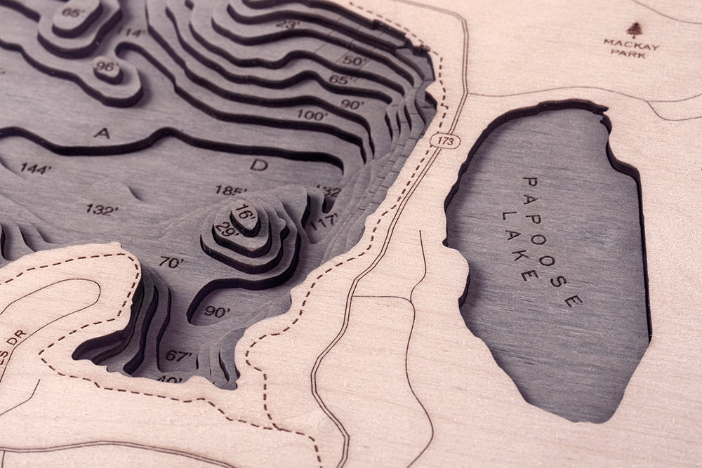 Lake Arrowhead, California 3D layered wood map in laser-cut Baltic birch, shown framed against a light wall