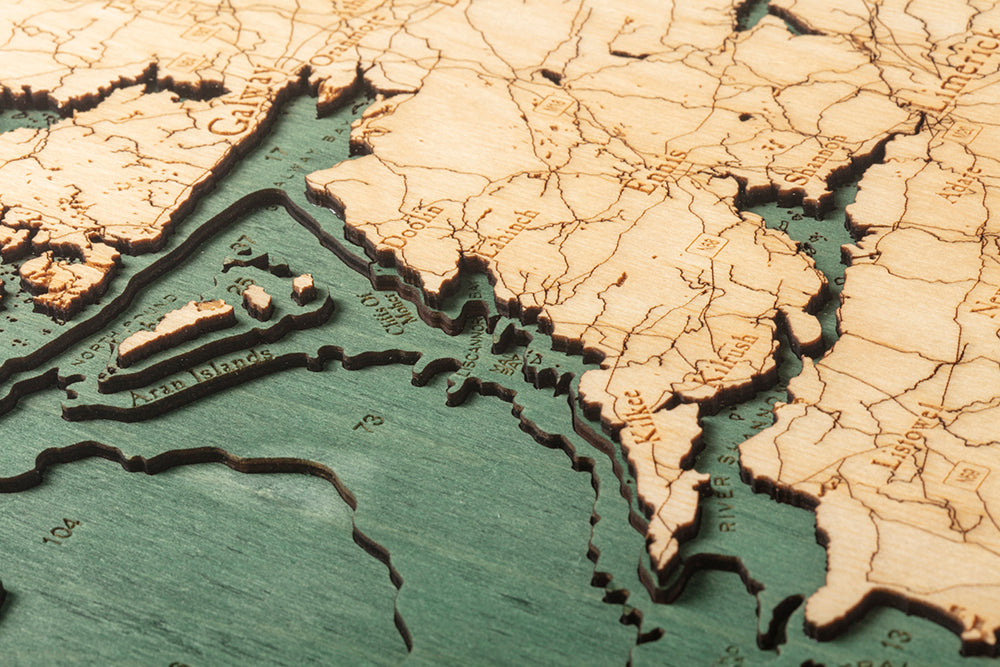 Ireland 3D layered wood map in laser-cut Baltic birch, shown framed against a light wall