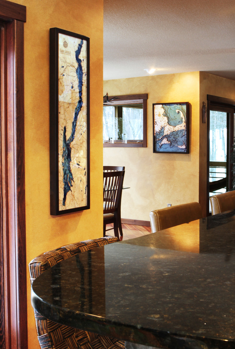 Carved wood lake maps on a dining room wall