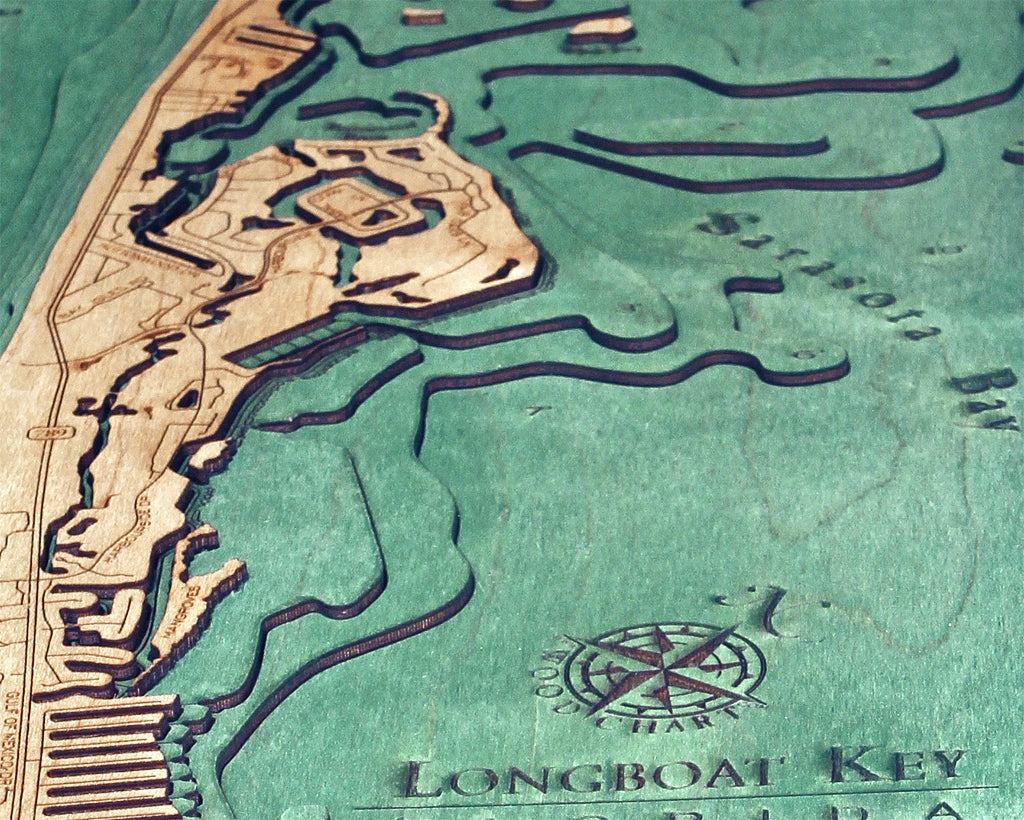 Longboat Key, Florida 3D layered wood map in laser-cut Baltic birch, shown framed against a light wall