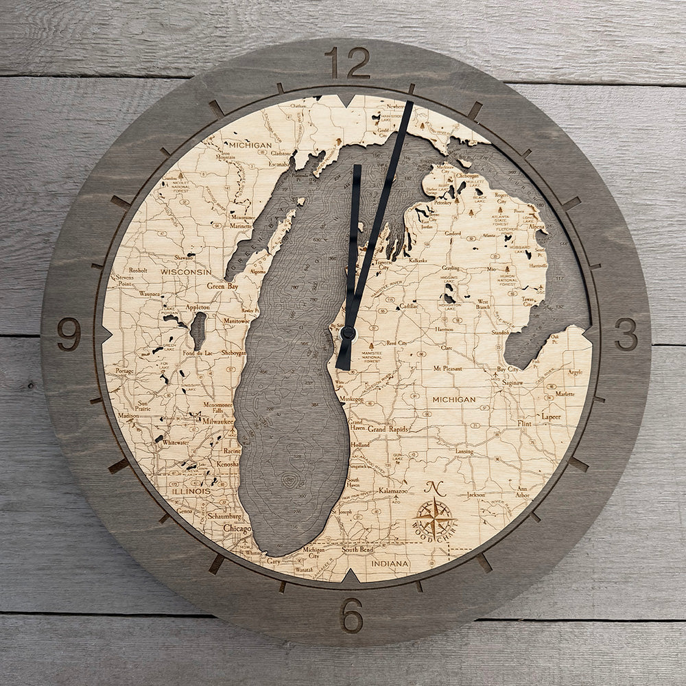 Lake Michigan wood wall clock in laser-cut Baltic birch, shown framed against a light wall